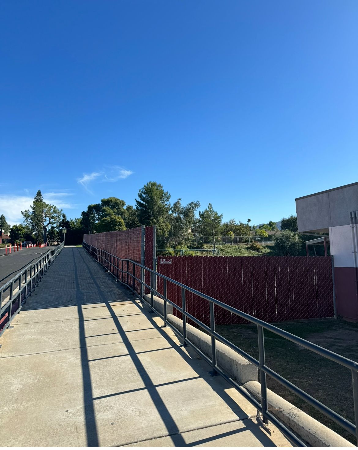 A Bridge With a Red Fence and a Blue Sky in the Background — Riverside, CA — Elrod Fence Co