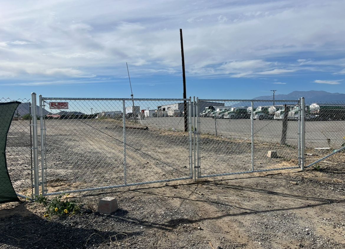 A Chain Link Fence Is in the Middle of a Dirt Field — Riverside, CA — Elrod Fence Co