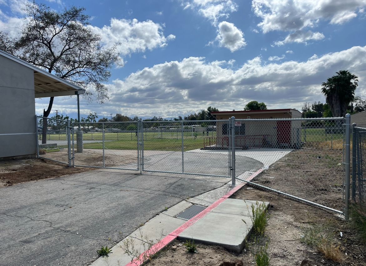 A Chain Link Fence Is Surrounding a Building in a Park — Riverside, CA — Elrod Fence Co