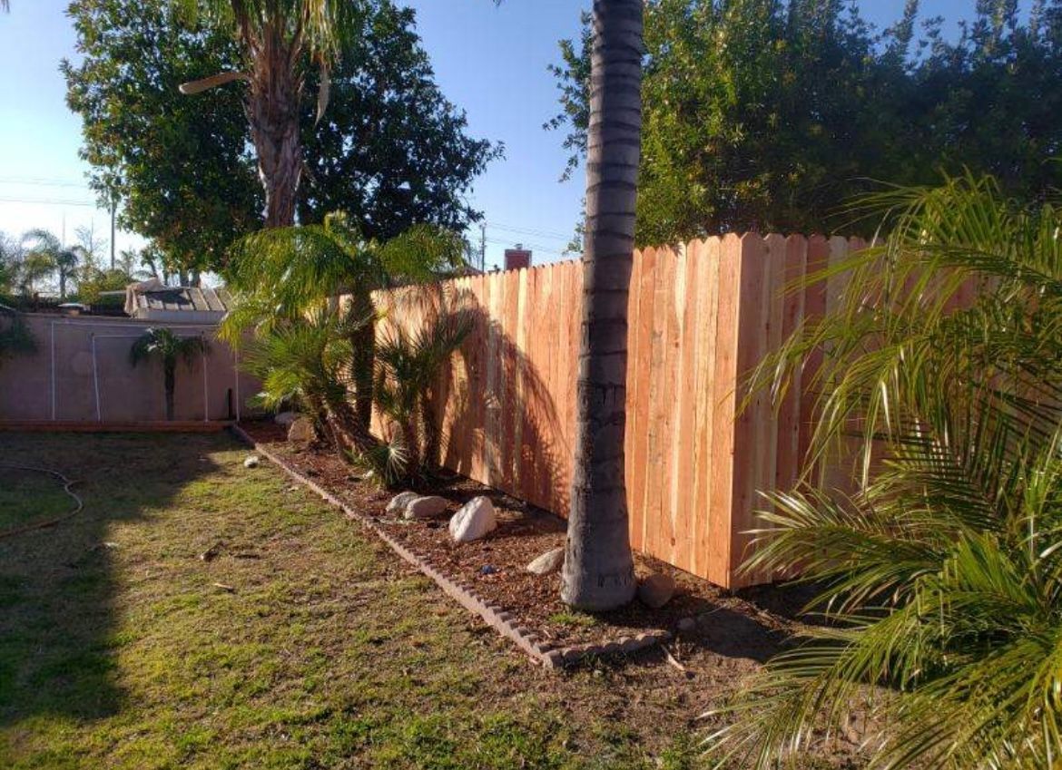 Wood Fence In The Backyard With Trees — Riverside, CA — Elrod Fence Co