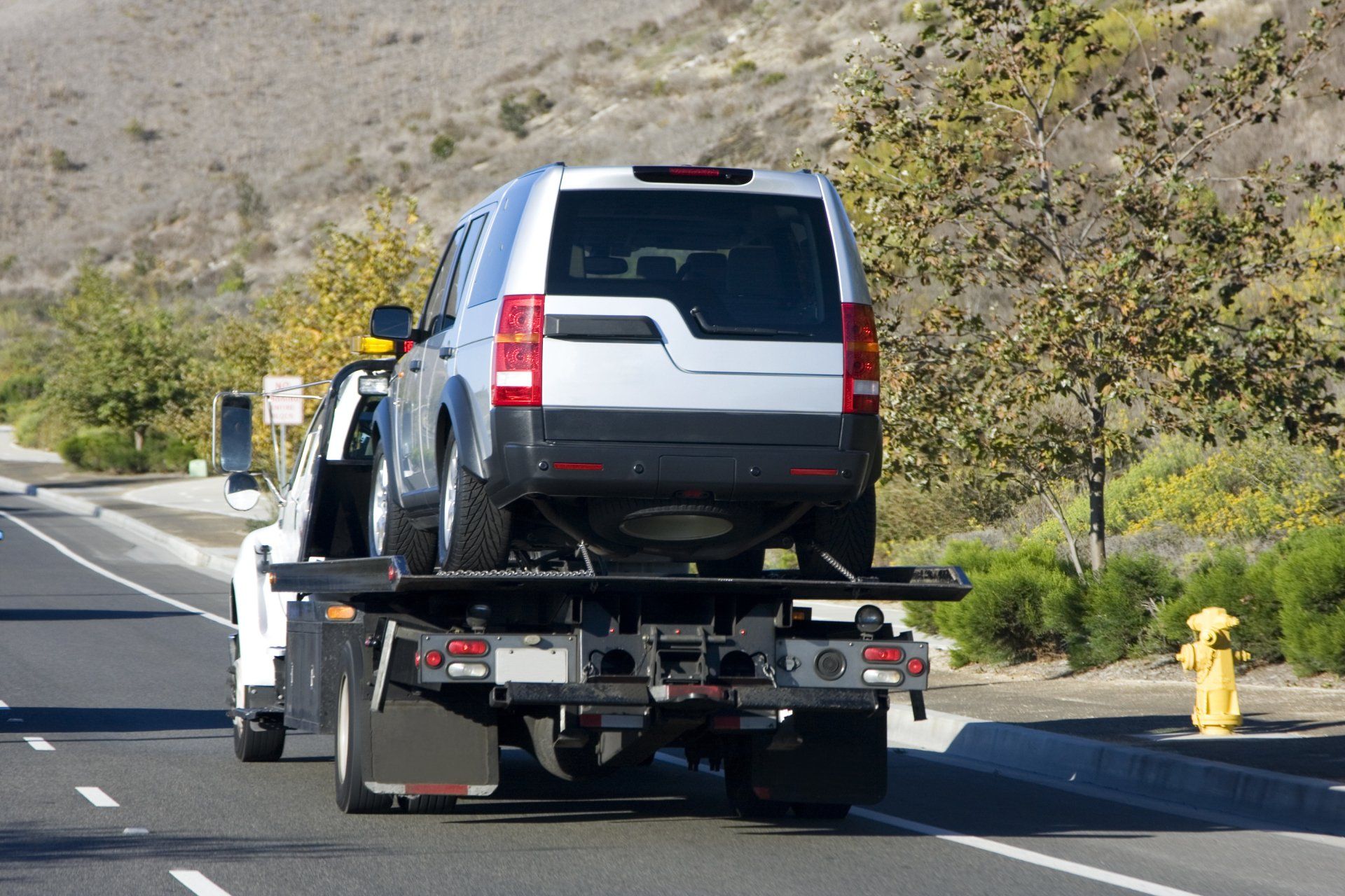 Car Being Carried by a Tow Truck — San Antonio, TX — Superior Hospice Car Being Carried by a Tow Truck — San Antonio, TX — Superior Hospice