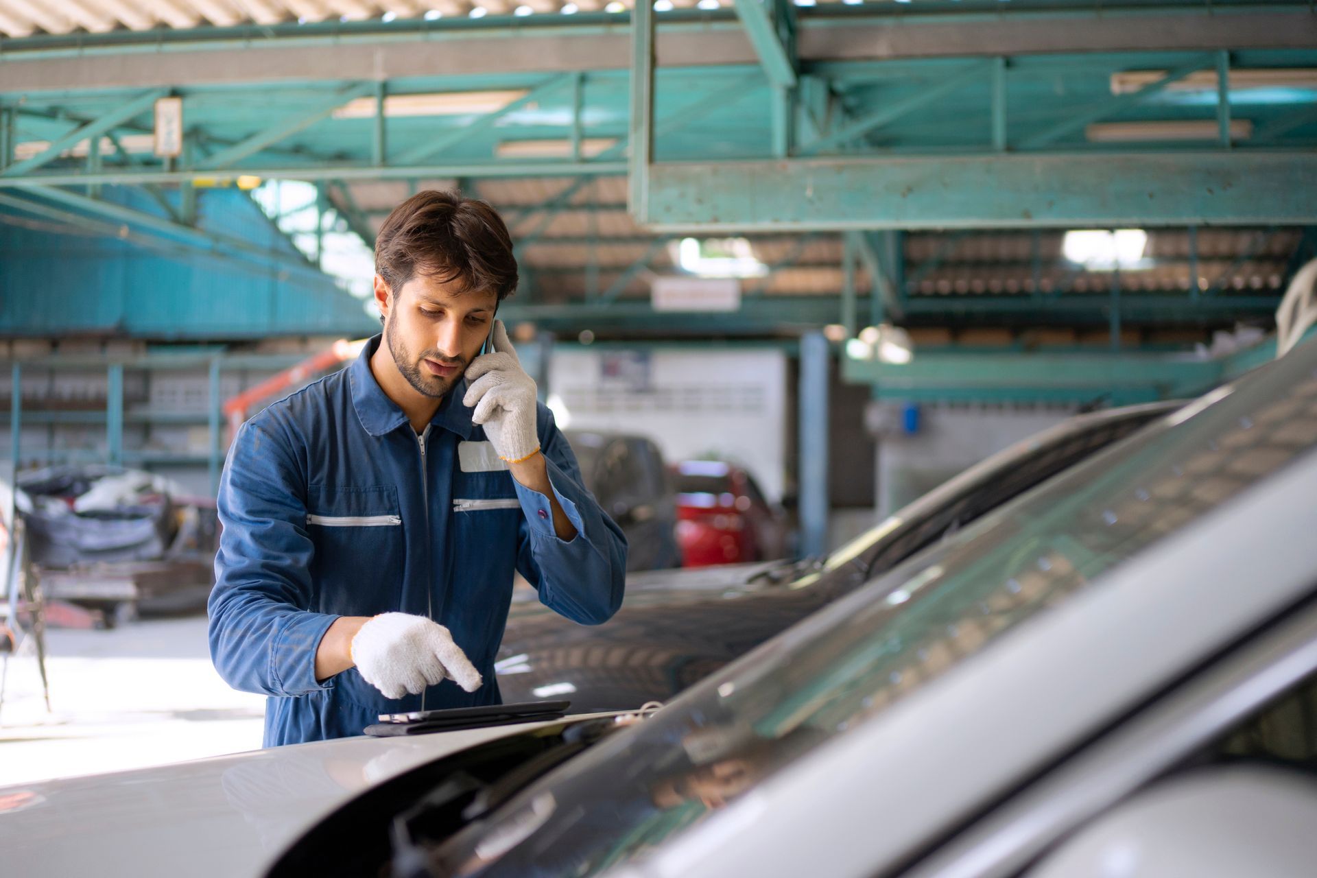 Mobile Auto Glass Repair Service Technician Fixing Windshield at Auto Shop