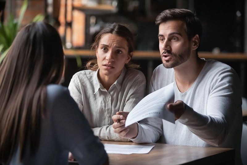 unhappy couple at lawyers office
