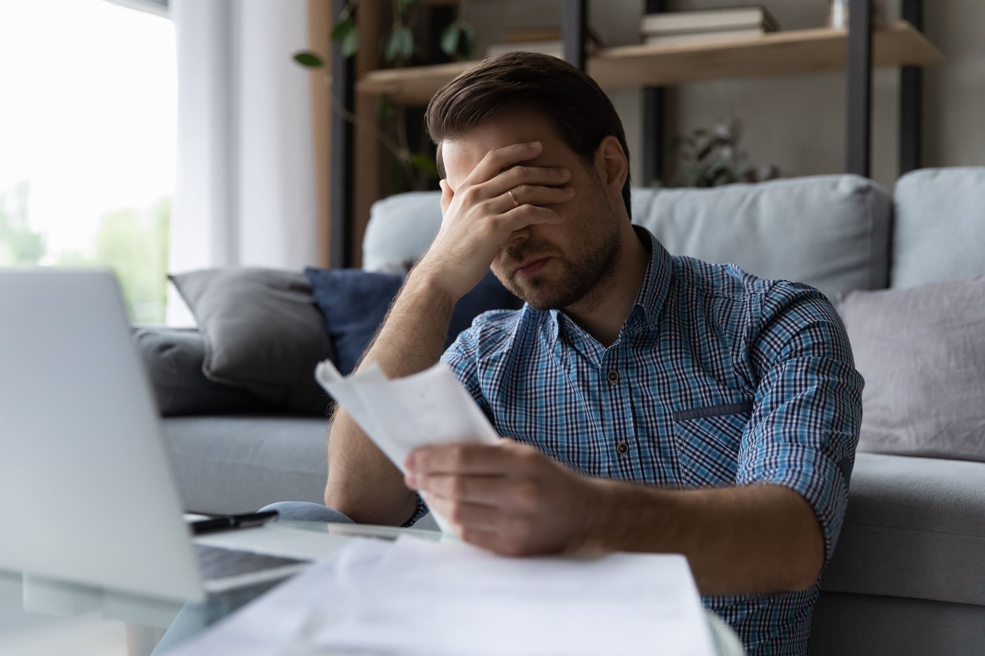 someone looking at paperwork frustrated