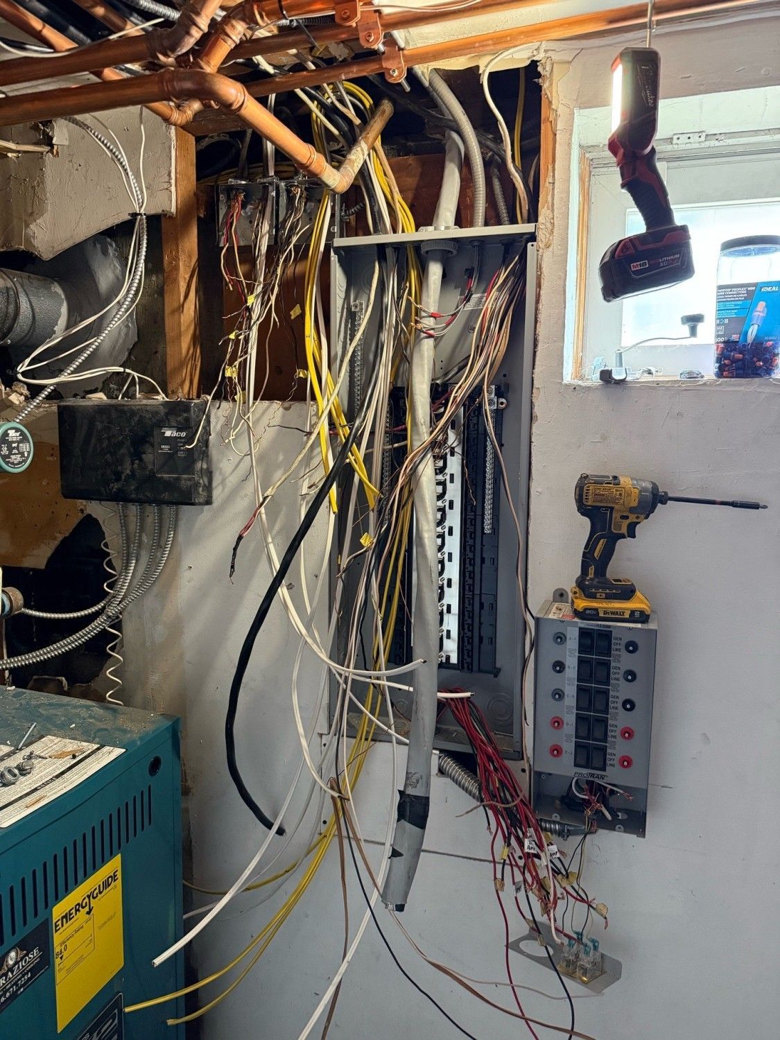 Hand turning off a circuit breaker in an electrical panel.