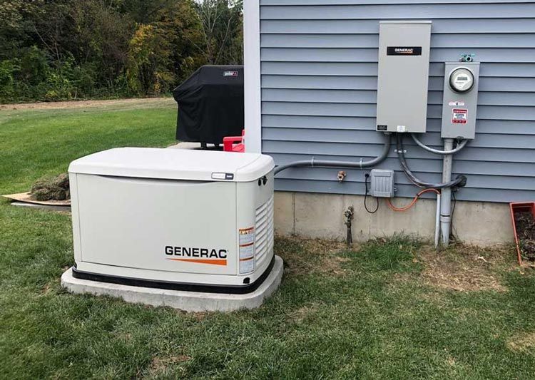 A Generac generator on a concrete pad next to a house with a utility meter and electrical panel.