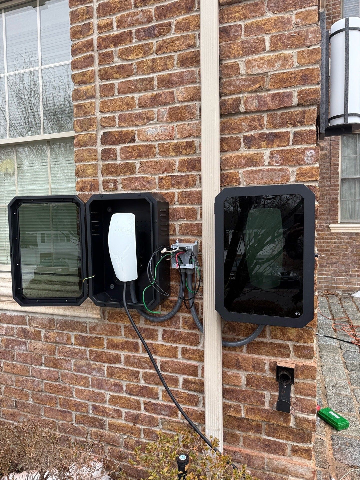 White EV charging at home; woman approaches front door.