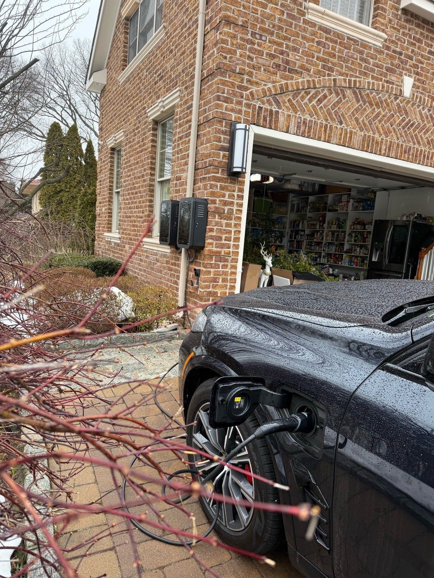 Electric car charging with a charging cable plugged in.