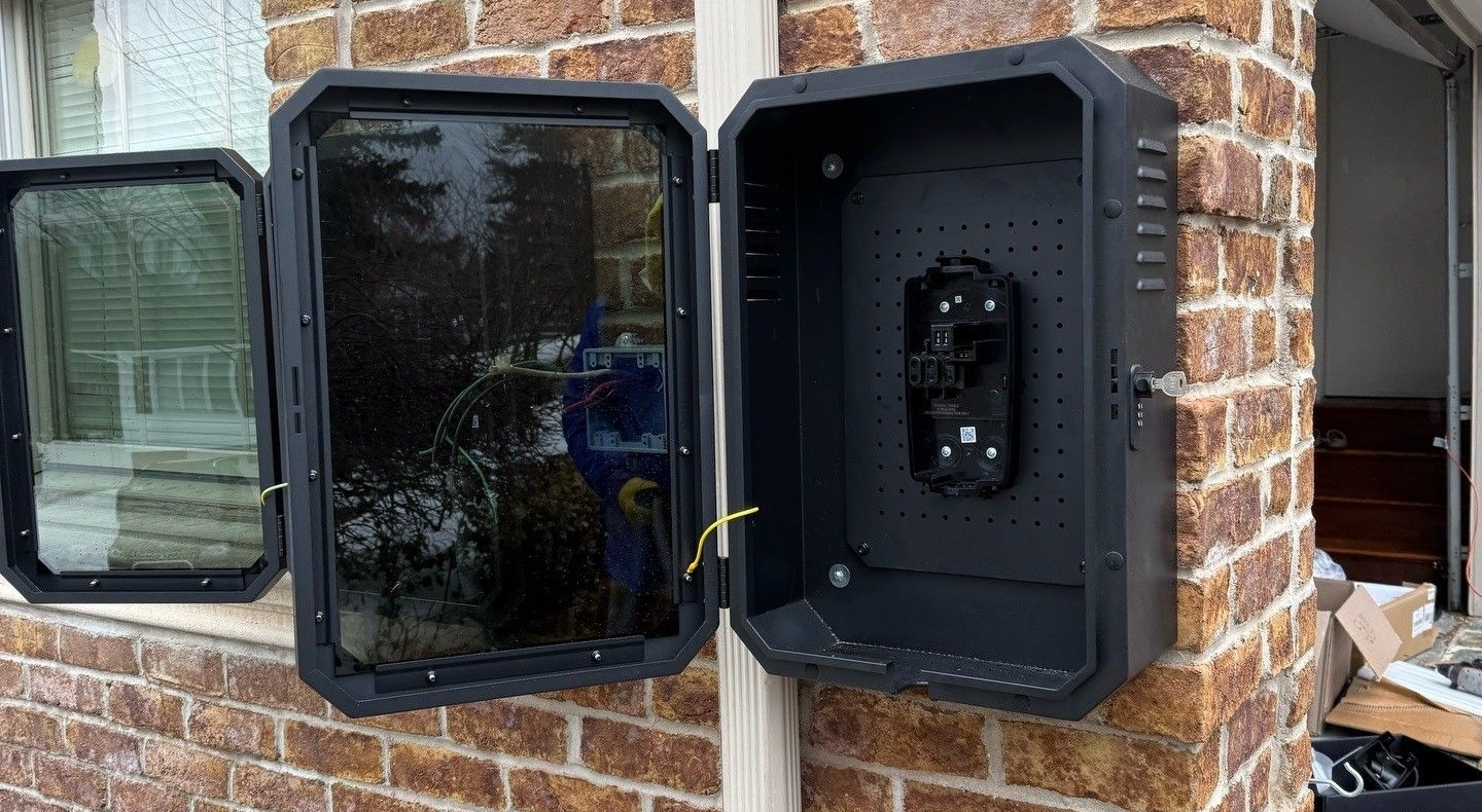 Electrician using a multimeter on a charging station installation.