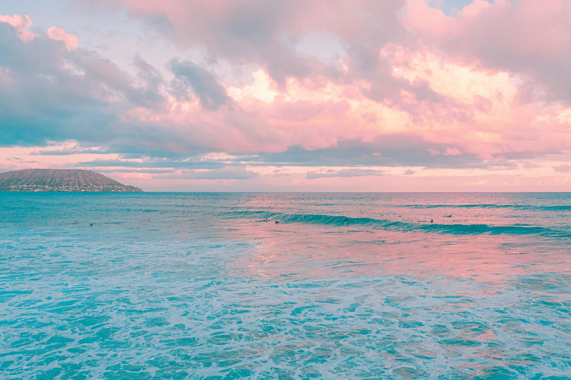 a pink sky with blue water