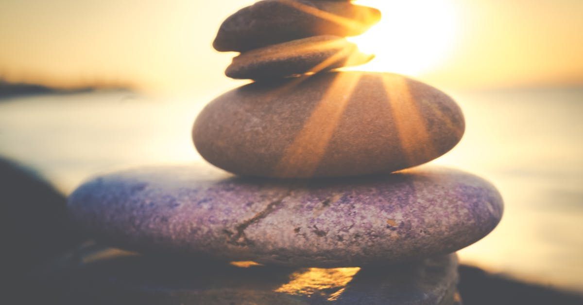 3 rocks stacked up and a yellow sun