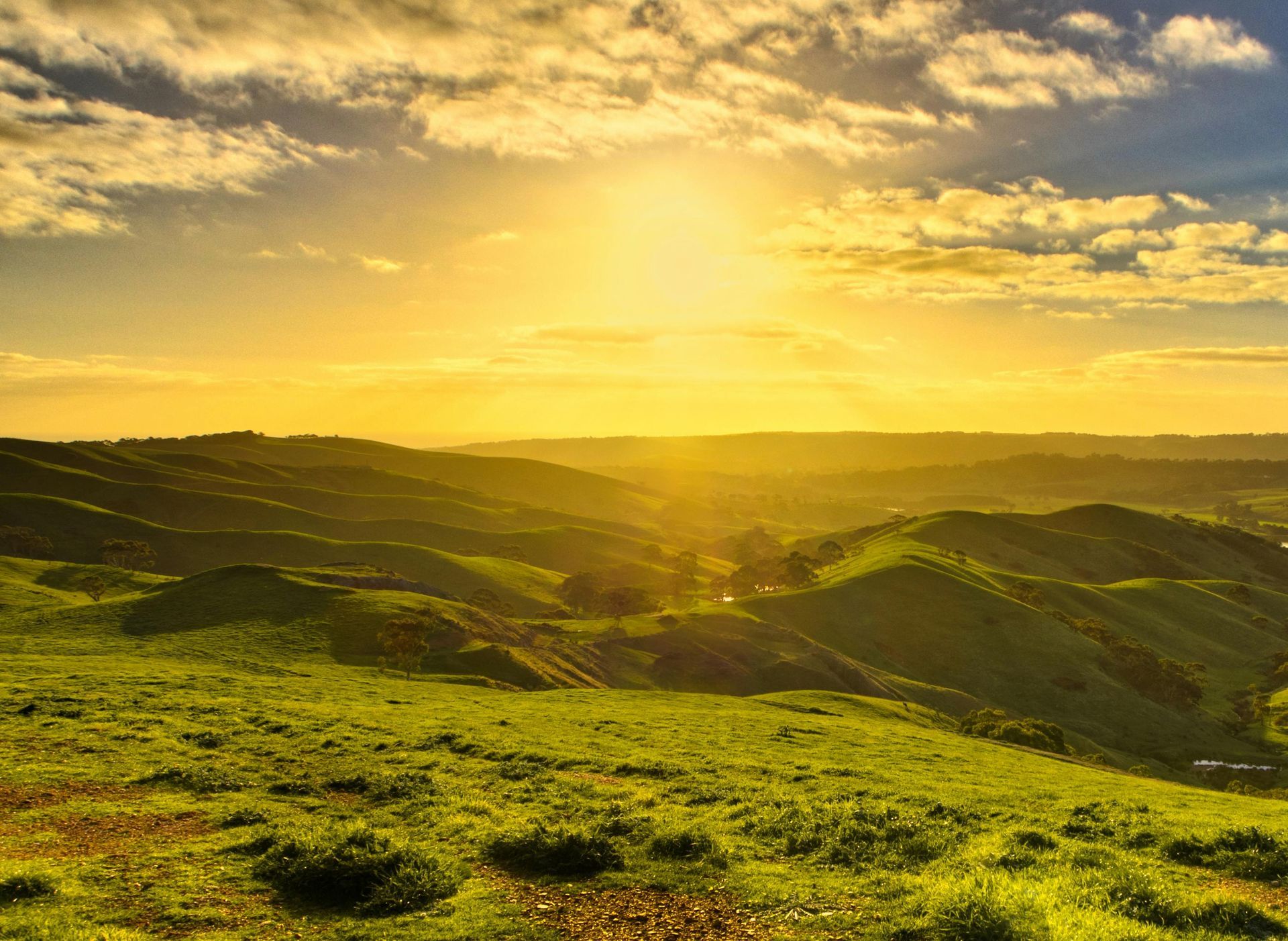 a sunlight over the green hills