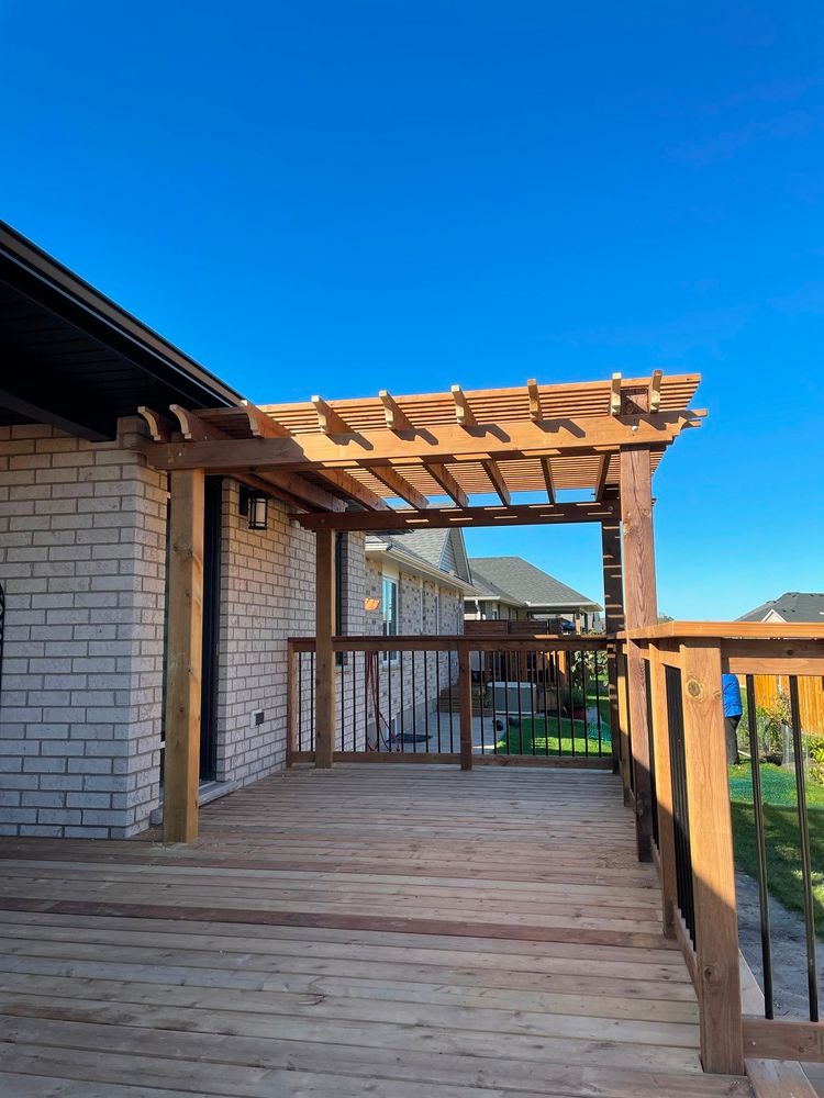 A wooden deck with a pergola on top of it.