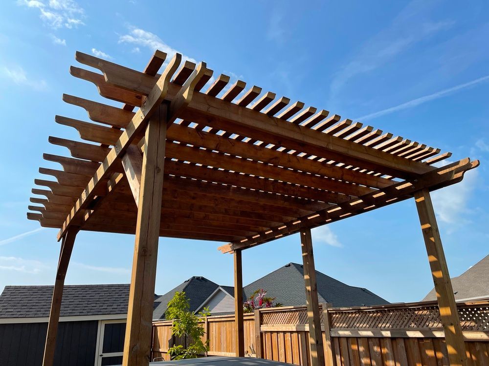 A wooden pergola with a blue sky in the background
