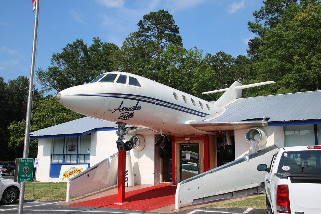 A large airplane is sitting on top of a building