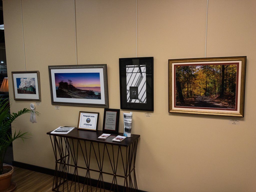 A room with a table and paintings on the wall.
