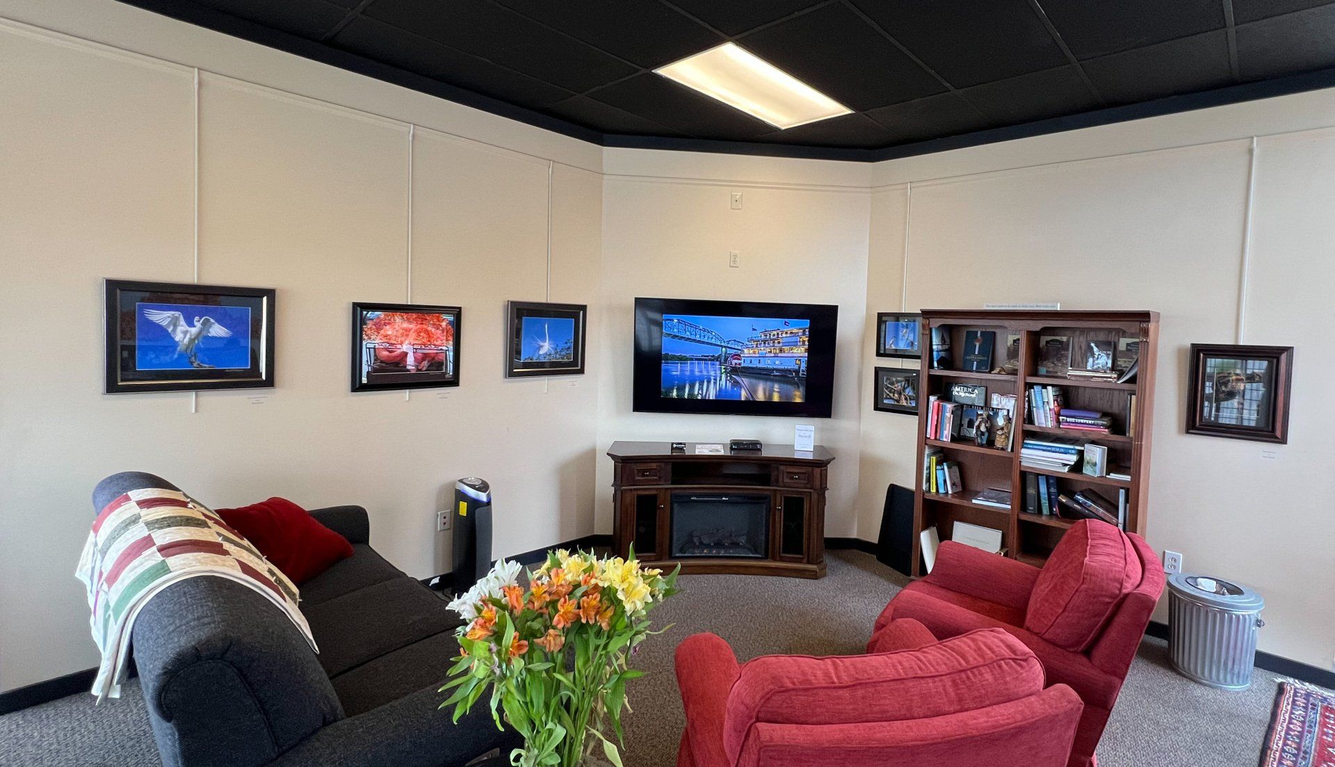 A living room with a couch and chairs and a flat screen tv