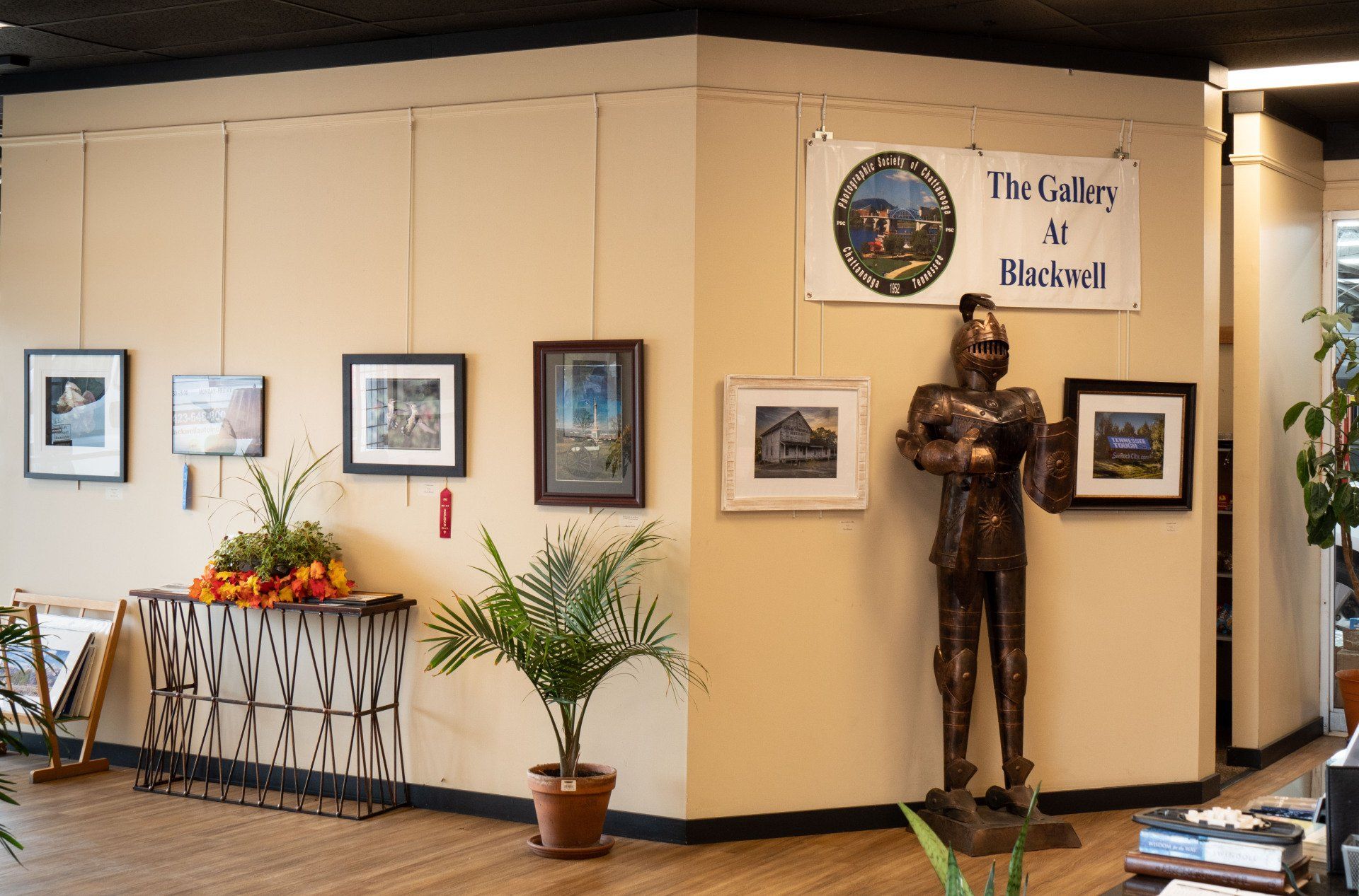 A room with a statue of a knight and a sign that says the gallery at detroit