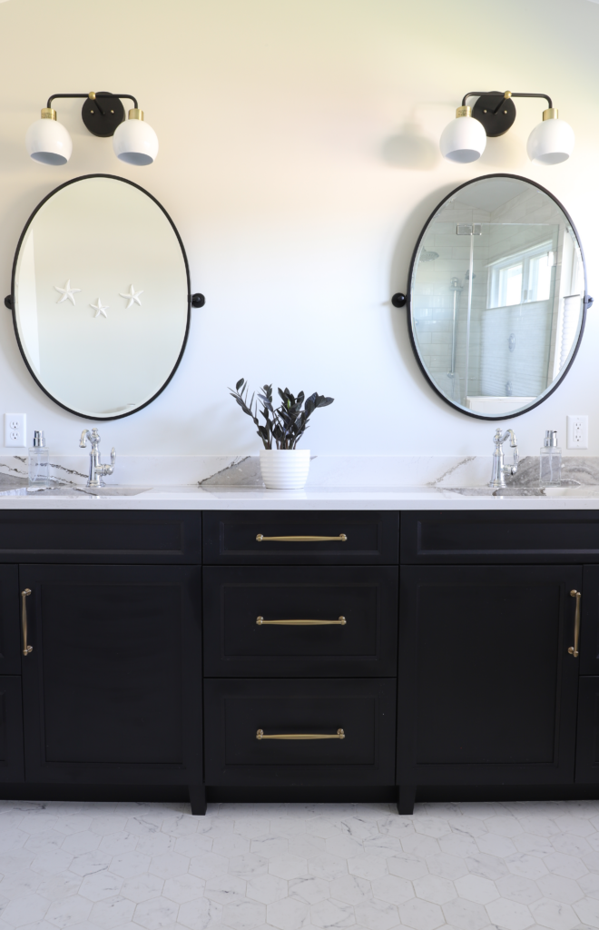 A bathroom with two sinks and two round mirrors