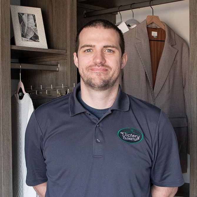 A man wearing a blue shirt with the word victory on it