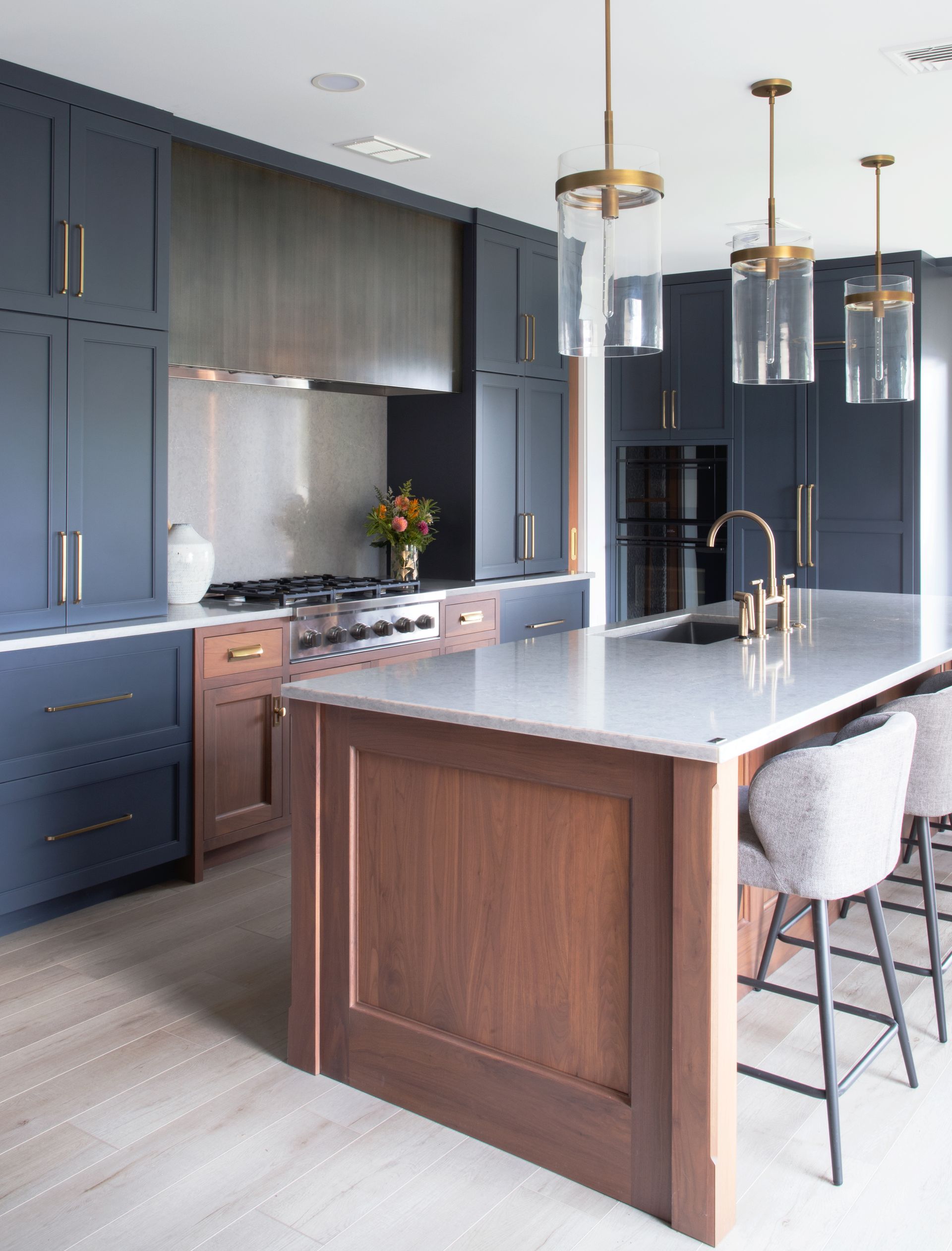 A kitchen with a large island and stools