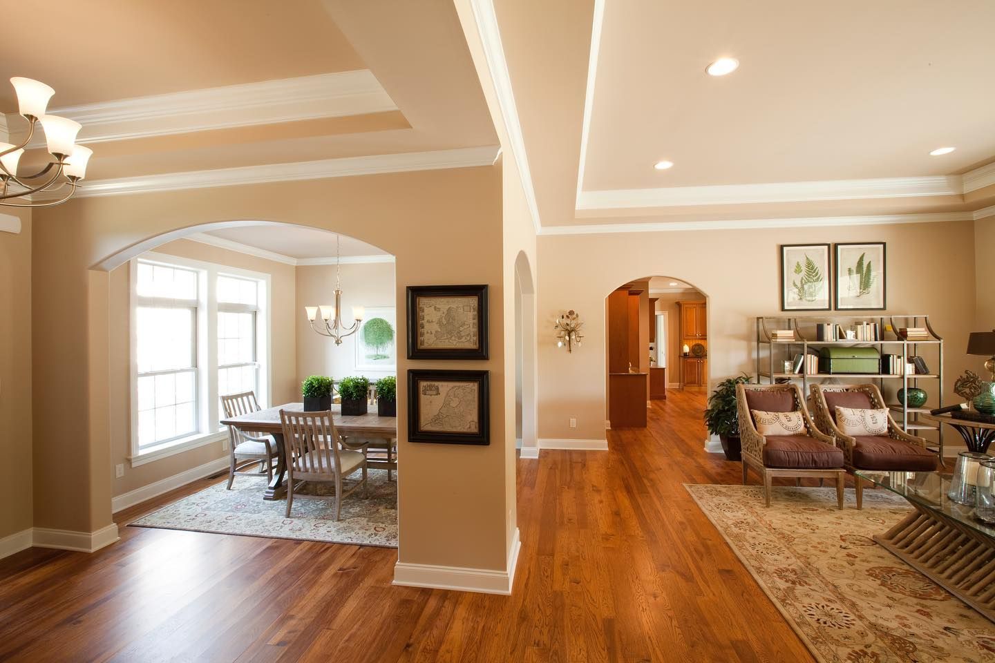 A living room and dining room in a house with hardwood floors
