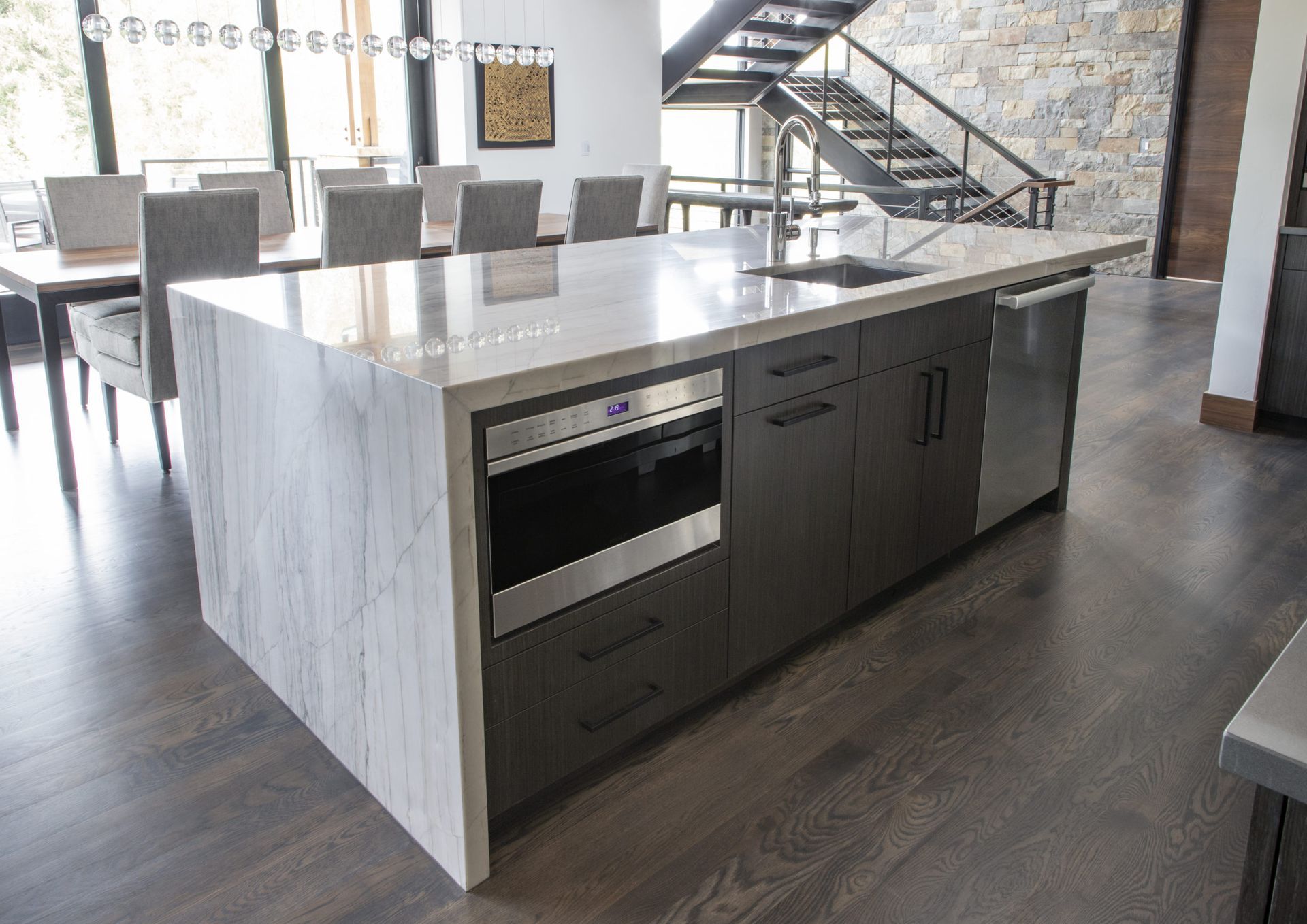 A kitchen with a large island and stainless steel appliances