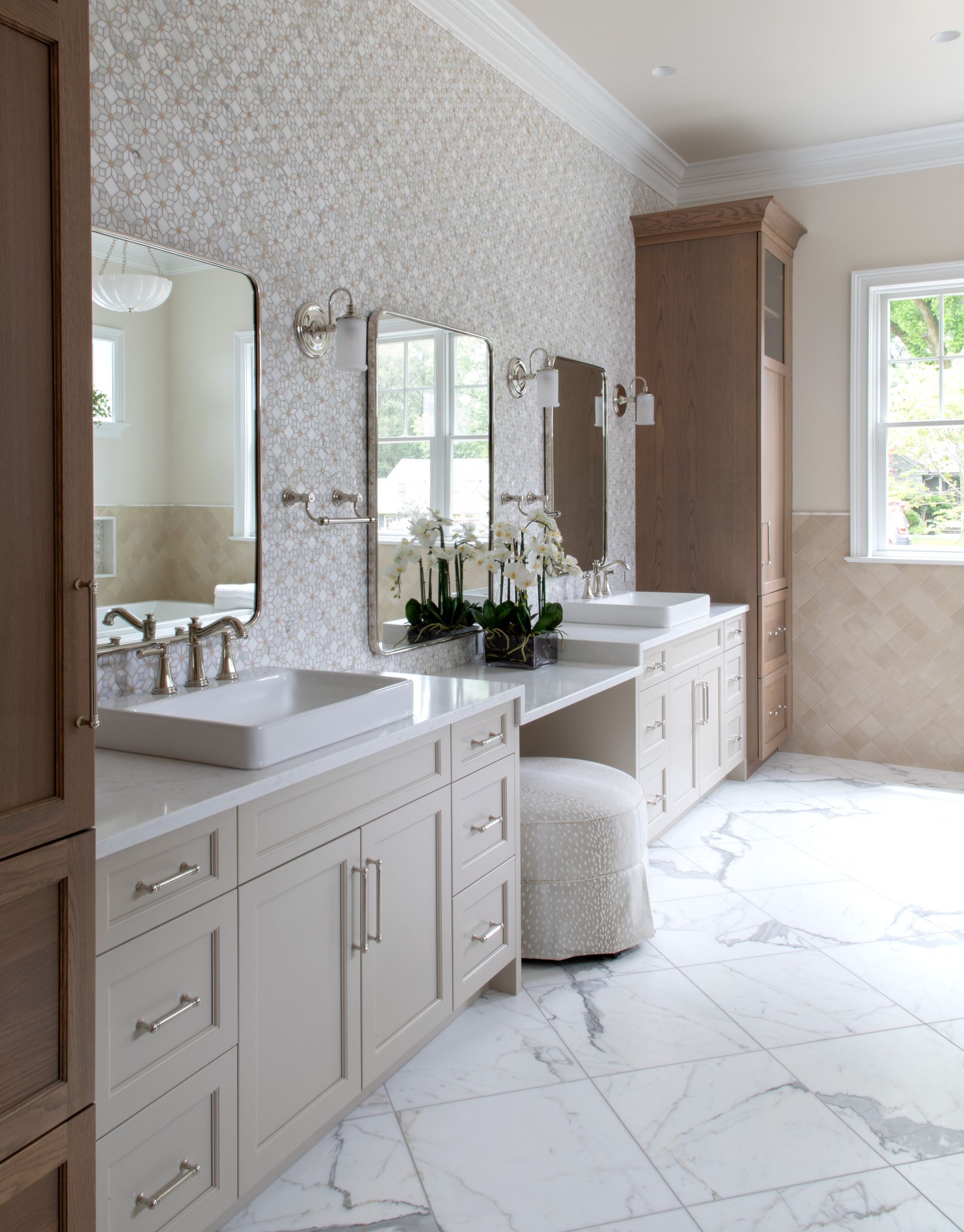 A bathroom with a sink , mirror and window.
