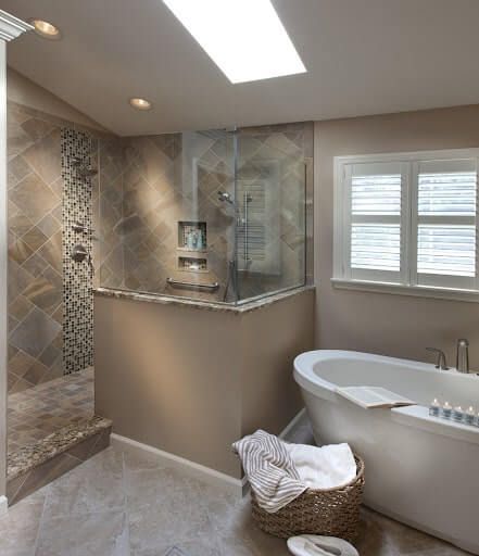 A bathroom with a tub and a walk in shower