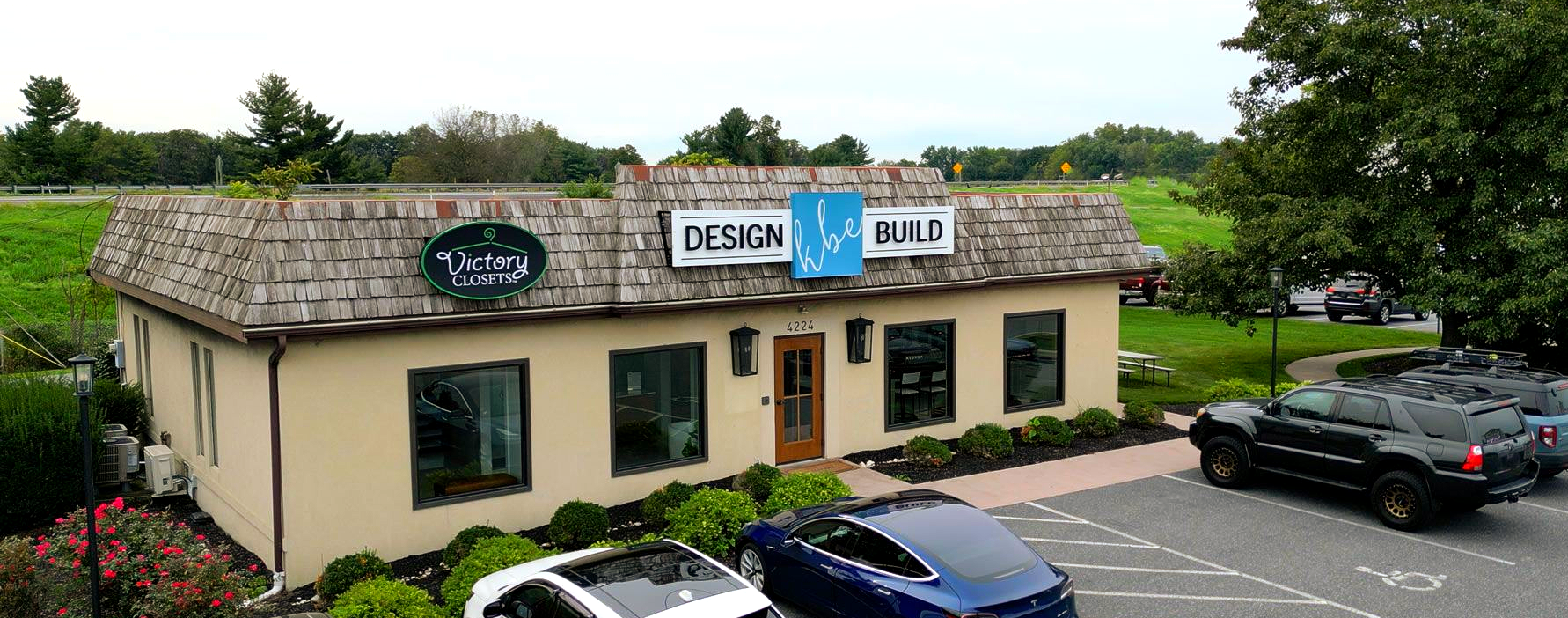 Exterior of a building with a shingled roof, signage 