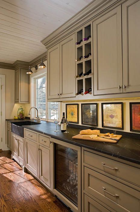 A kitchen with a bottle of wine on the counter.