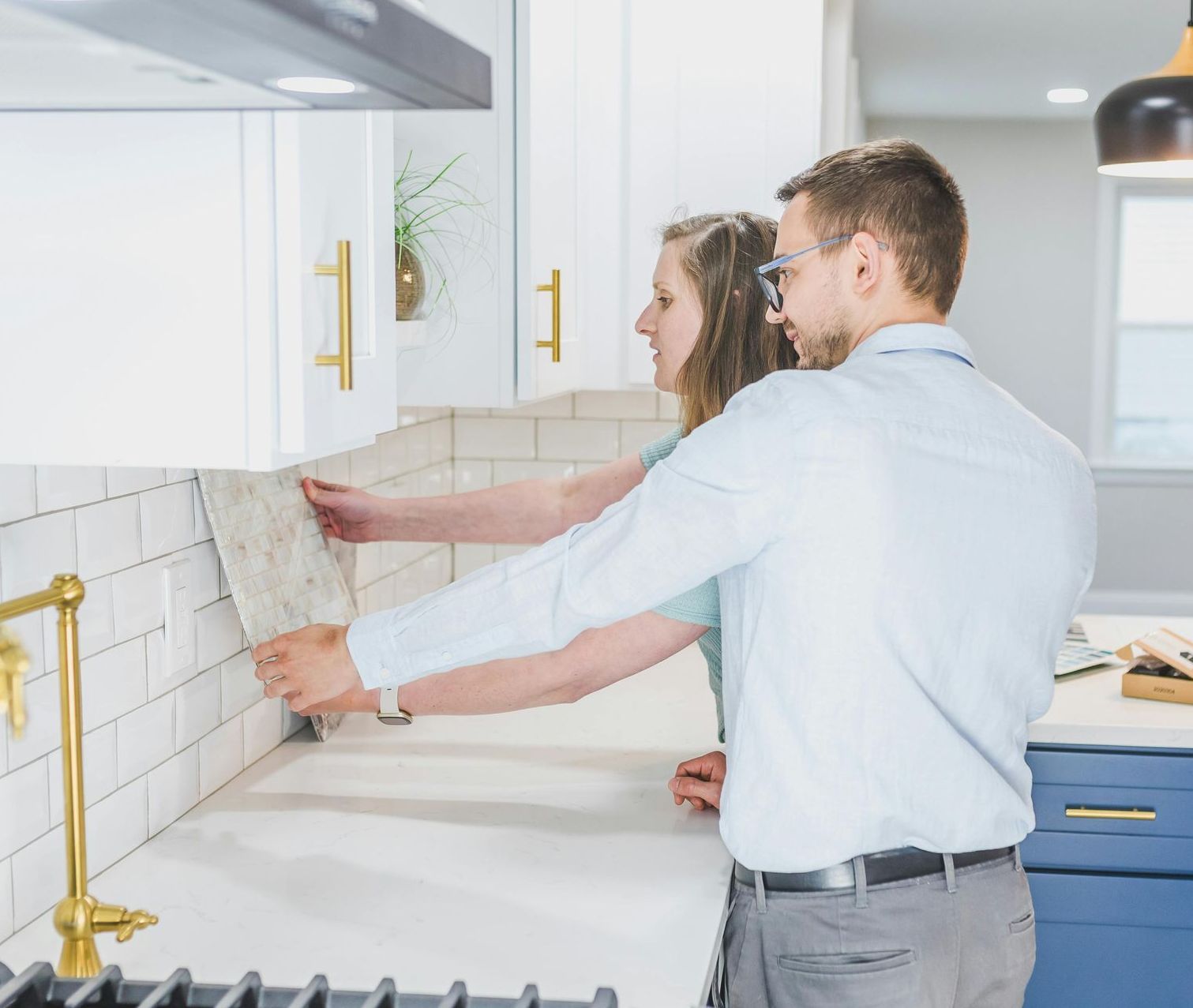 A man and a woman are standing in a kitchen.