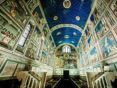 L'interno della Cappella degli Scrovegni, con il soffitto blu con stelle di Giotto e pareti ricoperte da affreschi biblici.