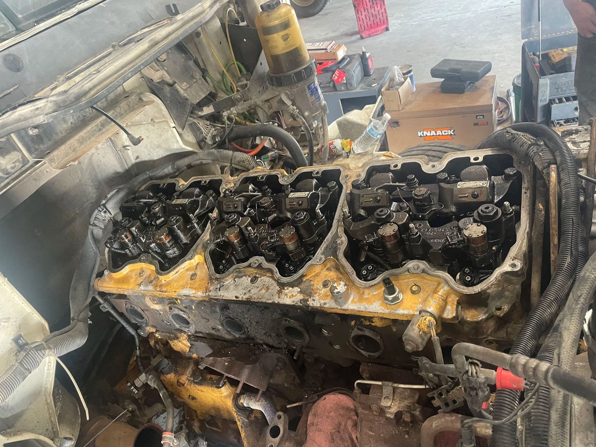 Burned car engine compartment with melted parts and smoke damage