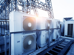 Rooftop HVAC unit under a bright blue sky.