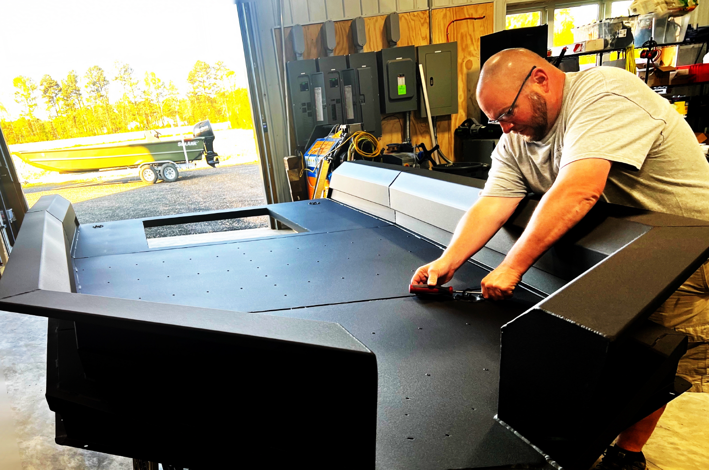 A man is working on modifying an invader hunting boat.