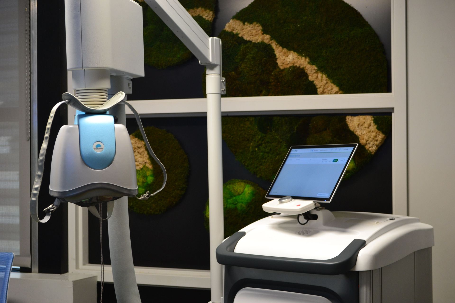Medical robot beside a touchscreen in a modern clinic room
