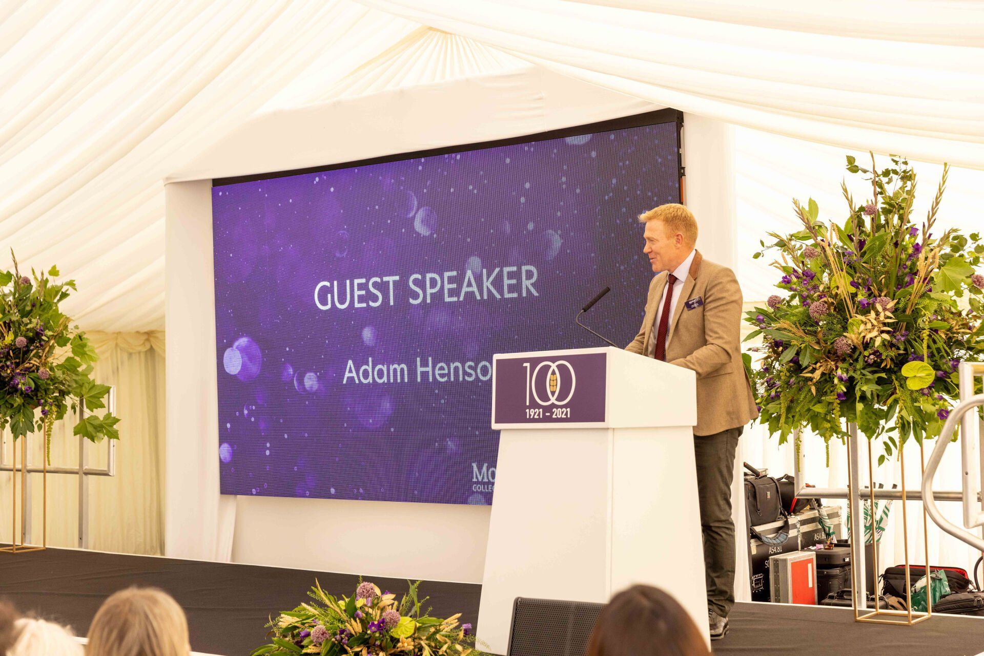 Man speaking at a podium with 