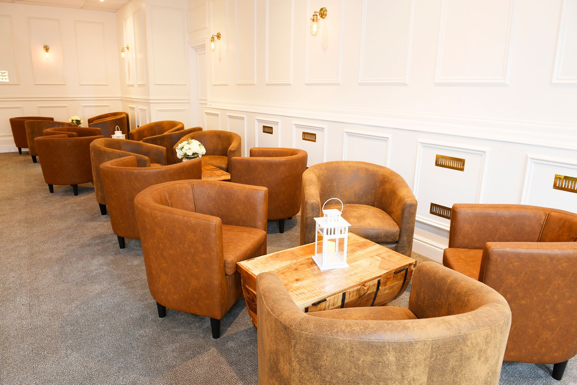 There are many chairs and tables in the room.