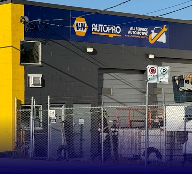 NAPA AutoPro automotive shop with blue and yellow facade, and a sign for all service automotive.
