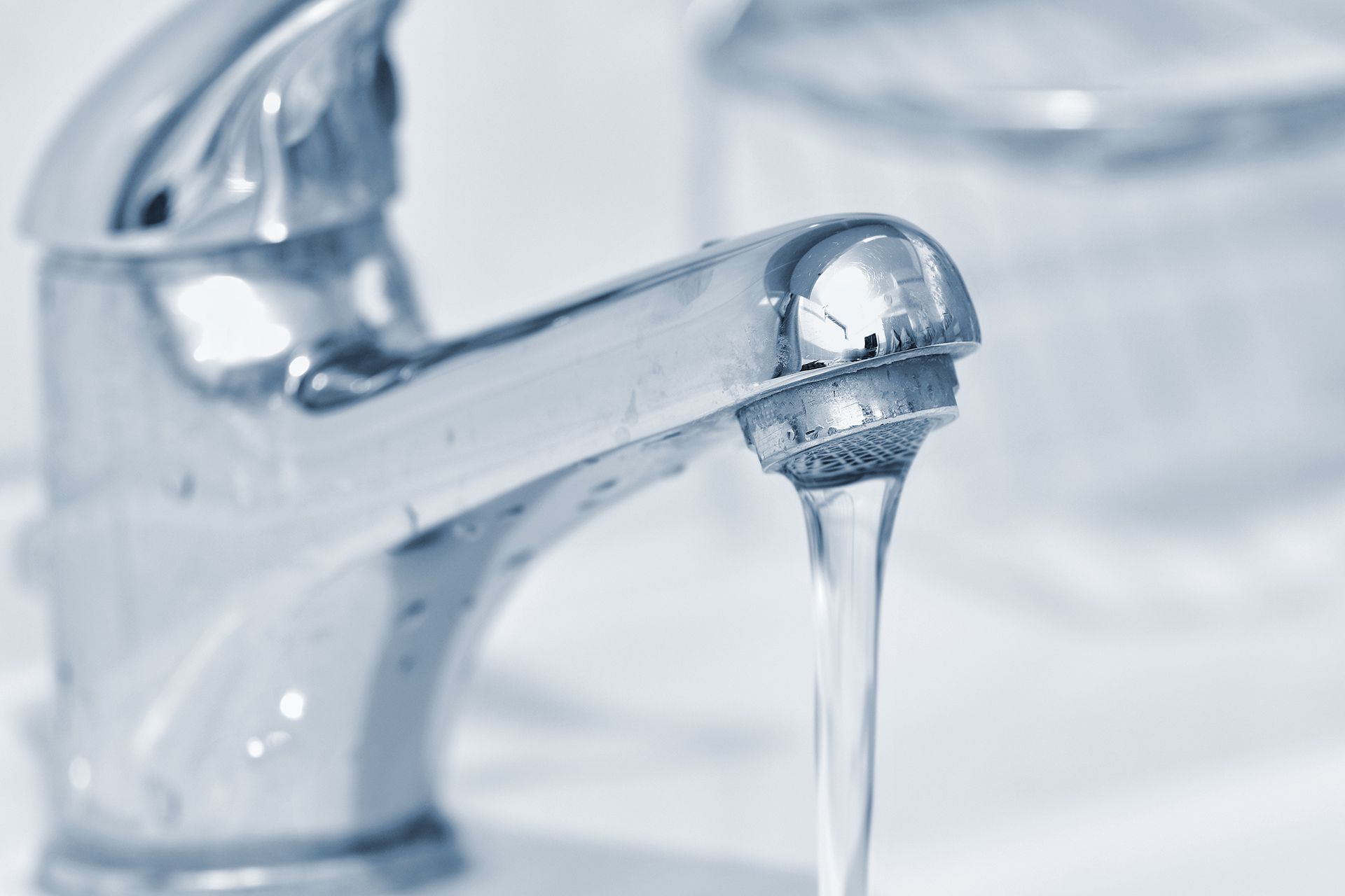 Chrome faucet with running water.