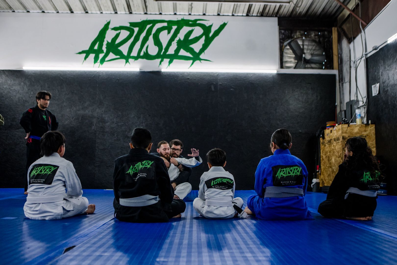 Adults and kids drilling Brazilian Jiu Jitsu at Artistry BJJ in Houston, TX, building fitness and confidence.
