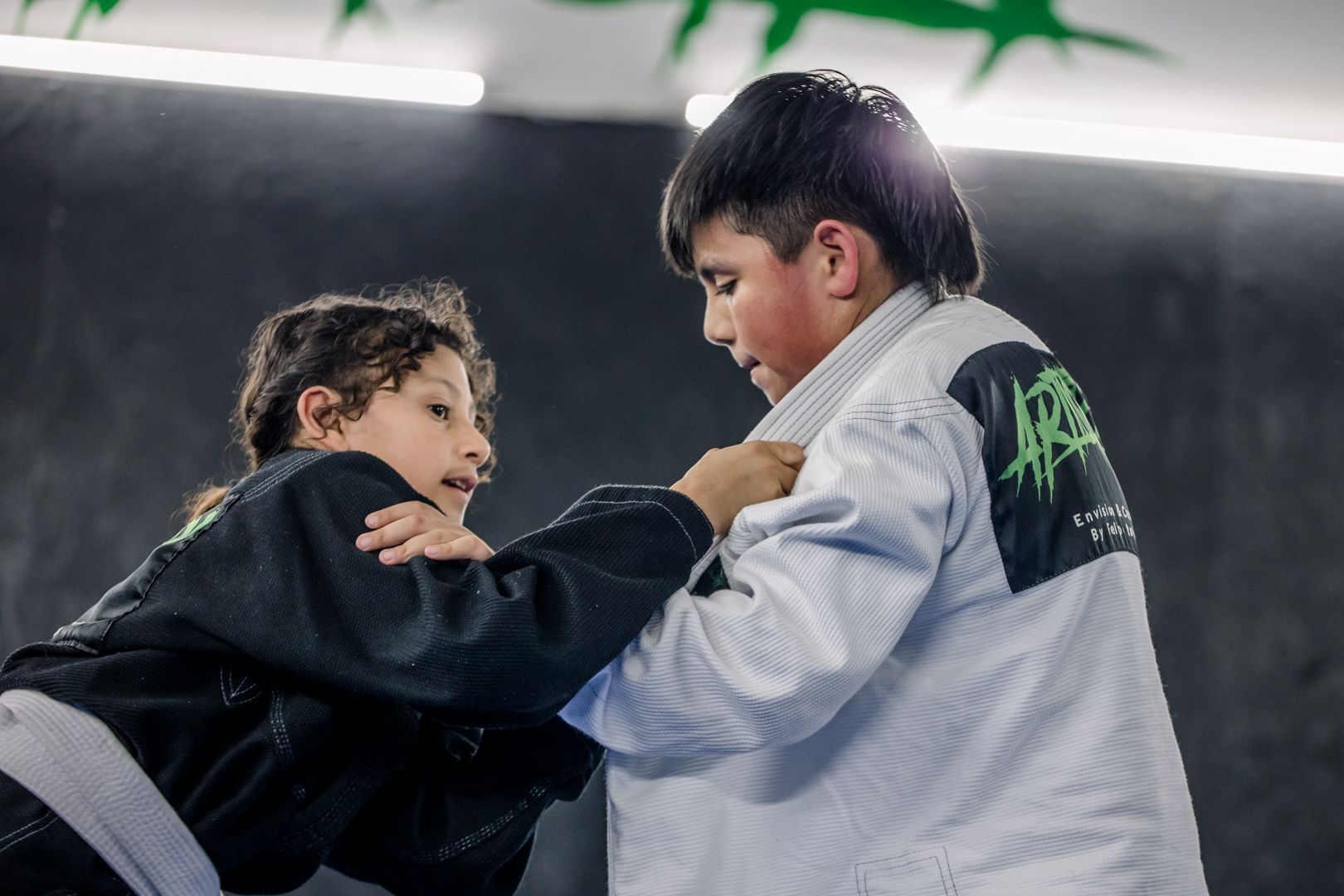 Kids practicing Brazilian Jiu Jitsu drills at Artistry BJJ in Houston, TX, building confidence through teamwork.