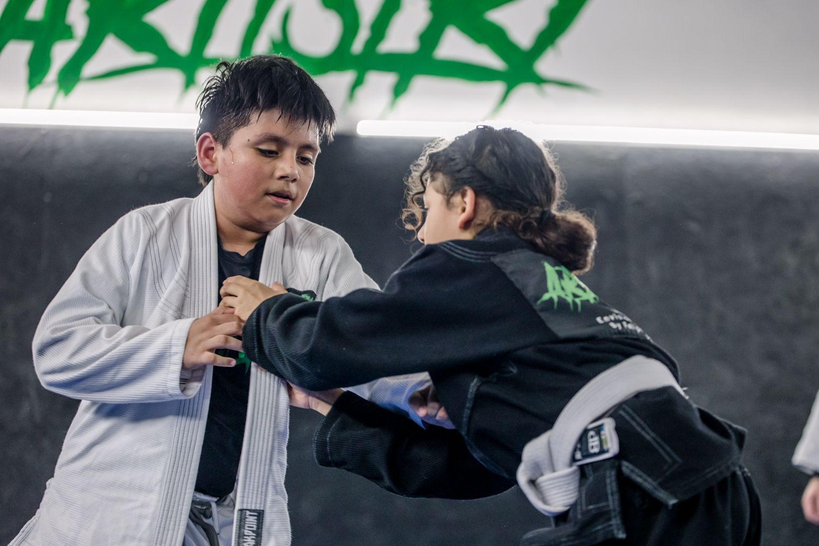 Kids practicing safe grappling drills at Artistry BJJ in Houston, TX, building confidence and focus.