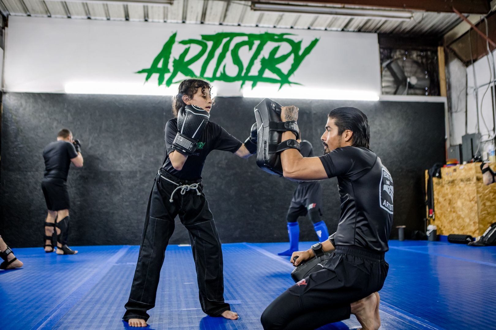 Kids practicing safe grappling drills at Artistry BJJ in Houston, TX, building confidence and focus.