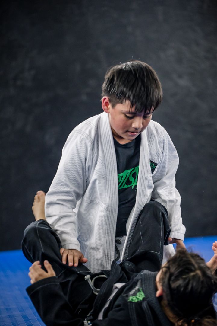 Kids practicing Youth Brazilian Jiu Jitsu at Artistry BJJ in Houston, Texas, building confidence.