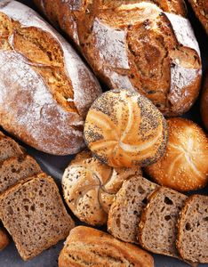 There are many different types of bread on the table.