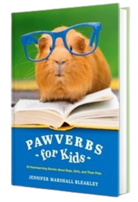 Book cover with a guinea pig in blue glasses reading an open book, titled “Pawverbs for Kids.”
