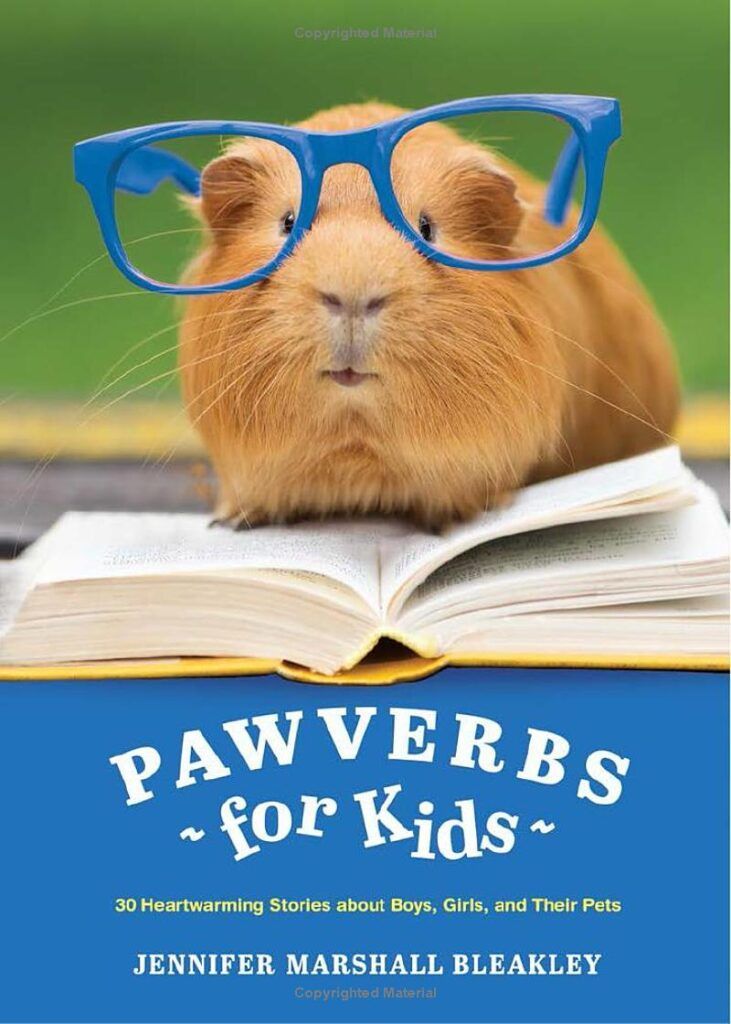 Guinea pig in blue glasses reading a book, with the title “Pawverbs for Kids” on a blue cover.