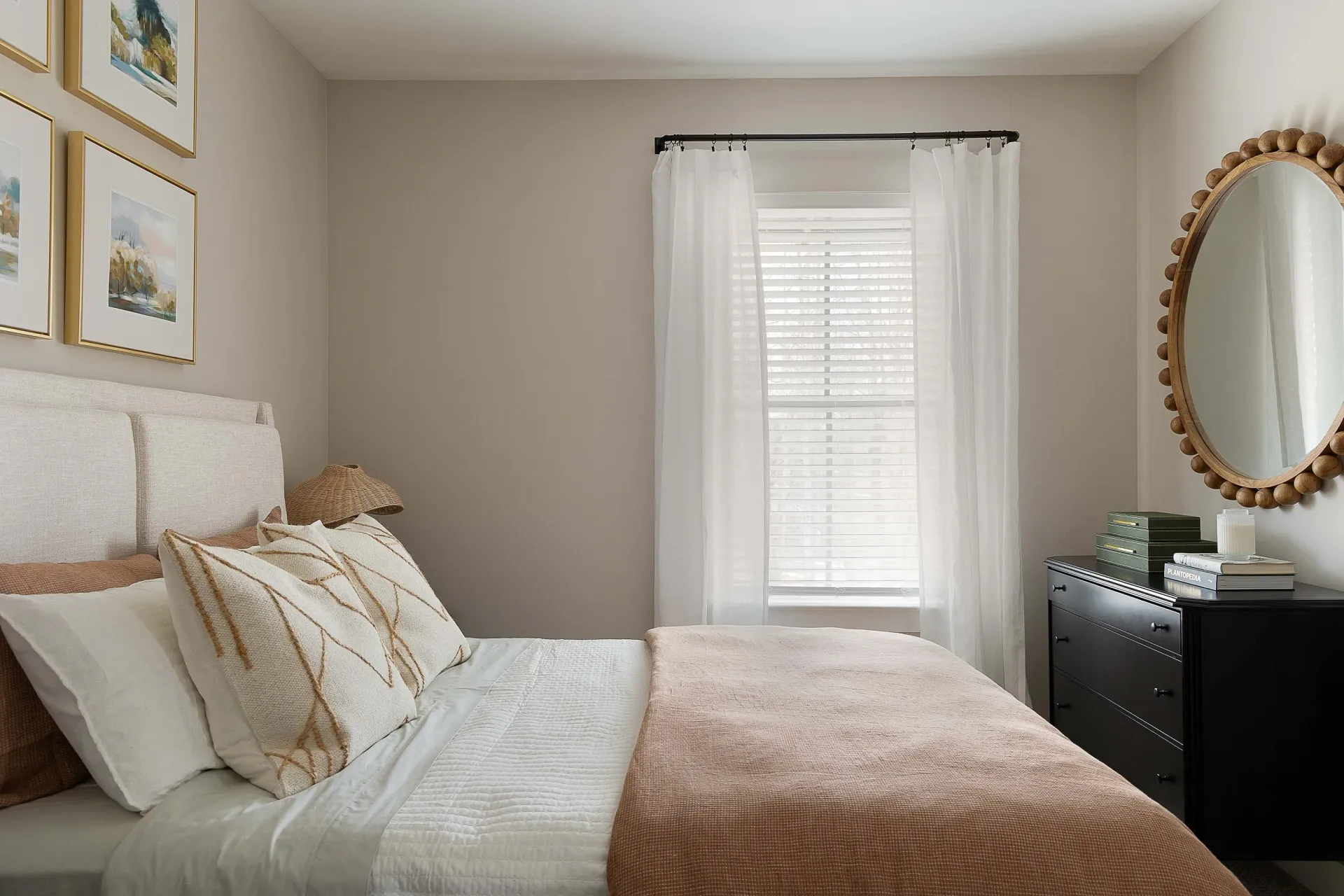 Cozy bedroom with a queen-sized bed, white bedding, and decorative pillows.